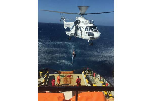 Joey Farrell is lowered via helicopter to a firefighting tug off Grand Canary. Photo courtesy Resolve Marine Group.