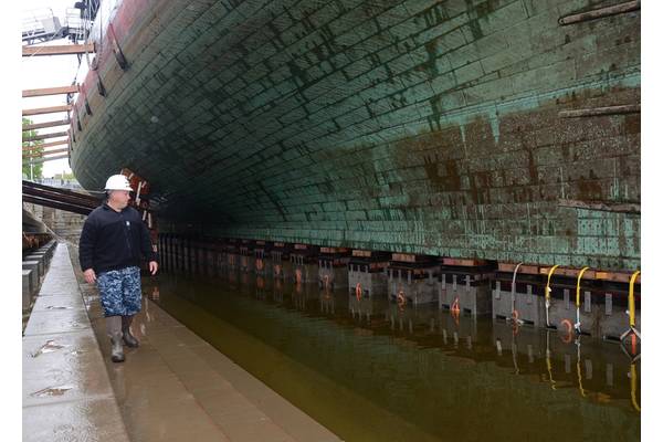 Cmdr. Sean D. Kearns, commanding officer of USS Constitution, conducts his first dry dock inspection of Old Ironsides near the conclusion of the dock's dewatering process.