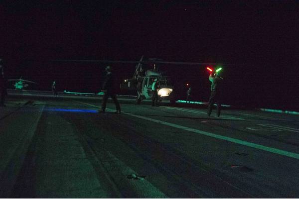 An MH-60S Sea Hawk helicopter assigned to the Tridents of Helicopter Sea Combat Squadron (HSC) 9 undergoes pre-flight checks on the flight deck of the aircraft carrier USS Dwight D. Eisenhower (CVN 69) before departing the ship to rescue distressed mariners. (U.S. Navy photo by Taylor L. Jackson)