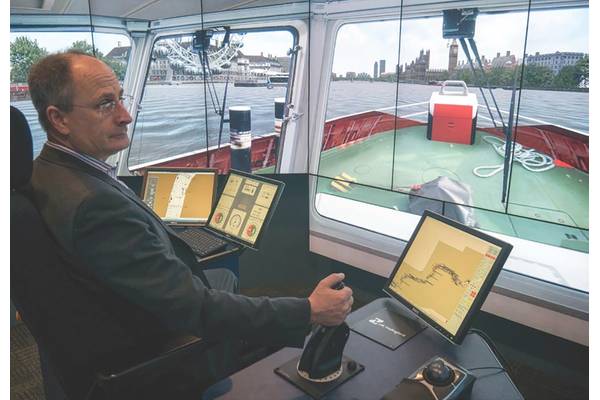Andy Mitchell, CEO of Tideway, at the helm of a tug in the Thames simulation (Photo: HR Wallingford)