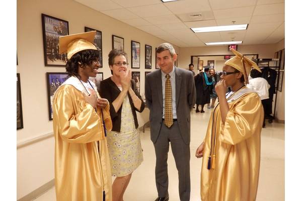 Mike and Nancy Petters congratulate An Achievable Dream Class of 2014 Valedictorian Taylor Braxton (left) and Salutatorian Briana Jones (right) for their achievements. (Photo courtesy of An Achievable Dream)