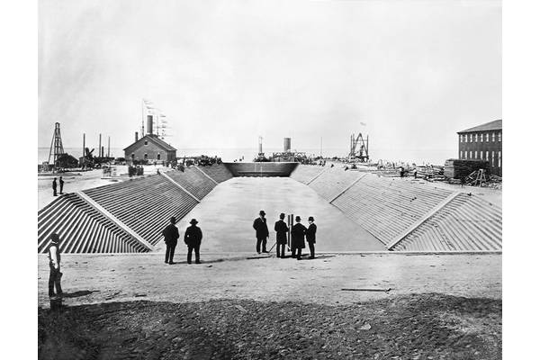 Dry Dock 1 at Newport News Shipbuilding is flooded prior to the official opening celebration of the shipyard's first dry dock on April 24, 1889.  The Puritan-class monitor USS Puritan waits beyond the dry dock’s gate to enter. (Photo: HII)