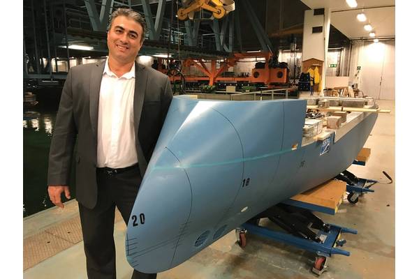 Nikolaos Doulis, Senior Vice President, New Buildings, Lindblad Expeditions, and the model of National Geographic Endurance at the tank testing facility, sporting Ulstein’s signature ‘XBow’. Photo: Lindblad Expeditions