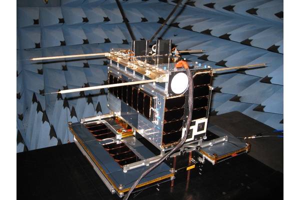 NORsat-1 in EMC test at SFL. Two AIS antennas may be seen at the top, and four Langmuir probes off to the sides. The solar wings of the satellite are at the bottom. (Photo: Space Flight Laboratory)