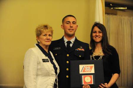 Petty Officer 2nd Class Bobby Hitchcock stands with his wife Amanda, right, and with Betty Howard, left, the national director of the Navy League of the United States. (U.S. Coast Guard photo by Anthony L. Soto)