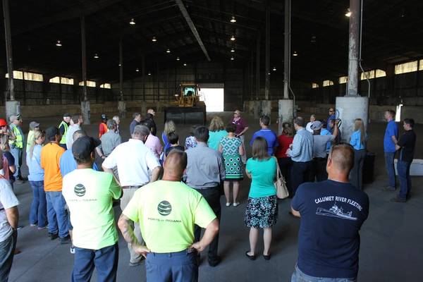 Ports of Indiana CEO, Rich Cooper (facing camera, purple shirt, sunglasses), addresses attendees during the Metro Ports Grand Opening at the Port of Indiana-Burns Harbor, July 18, 2017.  The event was held in the 56,000-square-foot dry bulk shed, which will be used to store a variety of bulk cargoes such as fertilizer, ore and magnesite. (Photo: Ports of Indiana)