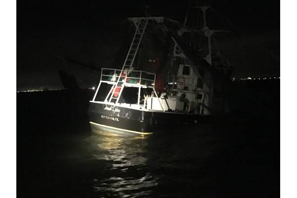 A shrimp boat sits grounded on South Galveston Jetty after three fisherman aboard were rescued by the Coast Guard. (U.S. Coast Guard photo by Tracy Mannes)
