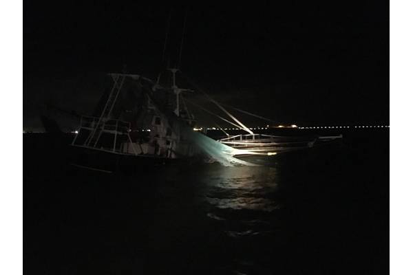 A shrimp boat sits grounded on South Galveston Jetty after three fisherman aboard were rescued by the Coast Guard. (U.S. Coast Guard photo by Tracy Mannes)