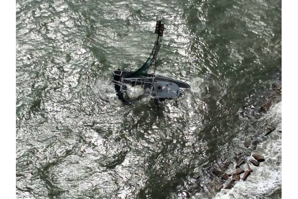 A shrimp boat is grounded on South Galveston Jetty after three fisherman aboard were rescued by the Coast Guard. (U.S. Coast Guard photo by Air Station Houston)