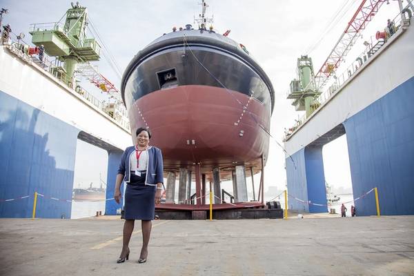 Lady Sponsor of the Usiba tug, Judith Nzimande, with the new tug which will serve at the Port of Richards Bay (Photo: TNPA)