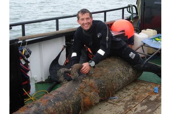 Vincent Woolsgrove with one of the Dutch cannons (Photo: Maritime and Coastguard Agency)