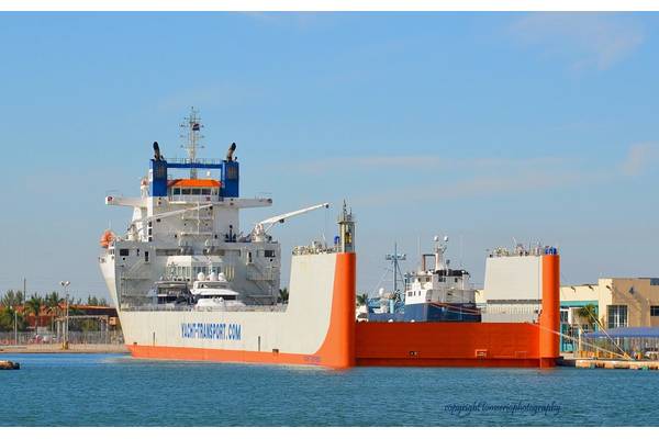 DYT Yacht Transport’s 686’ flagship Yacht Express is shown here in Port Everglades, Fla., before heading Down Under with its cargo of precious yachts, including the 126-foot research vessel M/V OCEARCH (blue hull). (photo credit Tom Serio Photography).