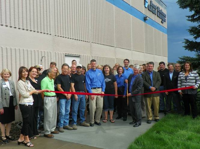 Joined by Jet Edge employees and local business and government leaders, Jet Edge President Jude Lague cuts a ribbon to mark Jet Edge’s 30th anniversary in the waterjet industry. The ribbon cutting was coordinated by the I-94 West Chamber of Commerce.  Photo courtesy I-94 West Chamber of Commerce.